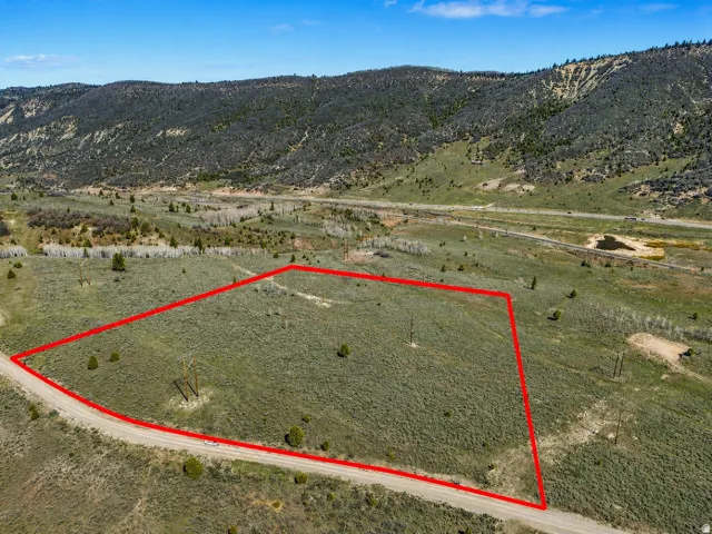 Expansive undeveloped land featuring natural terrain and distant mountains