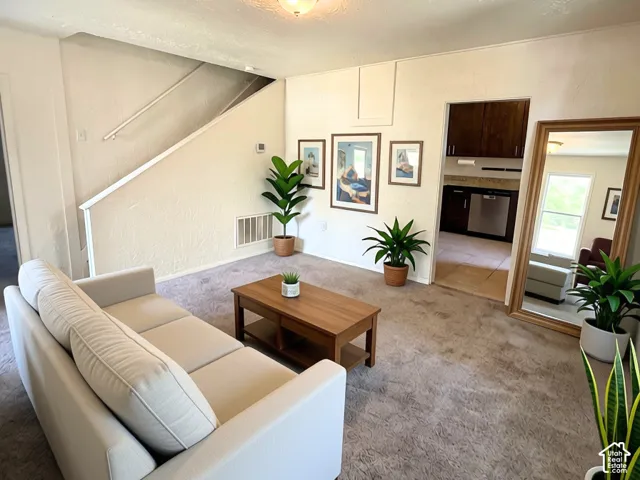 Neutral-toned walls complement the carpeted flooring