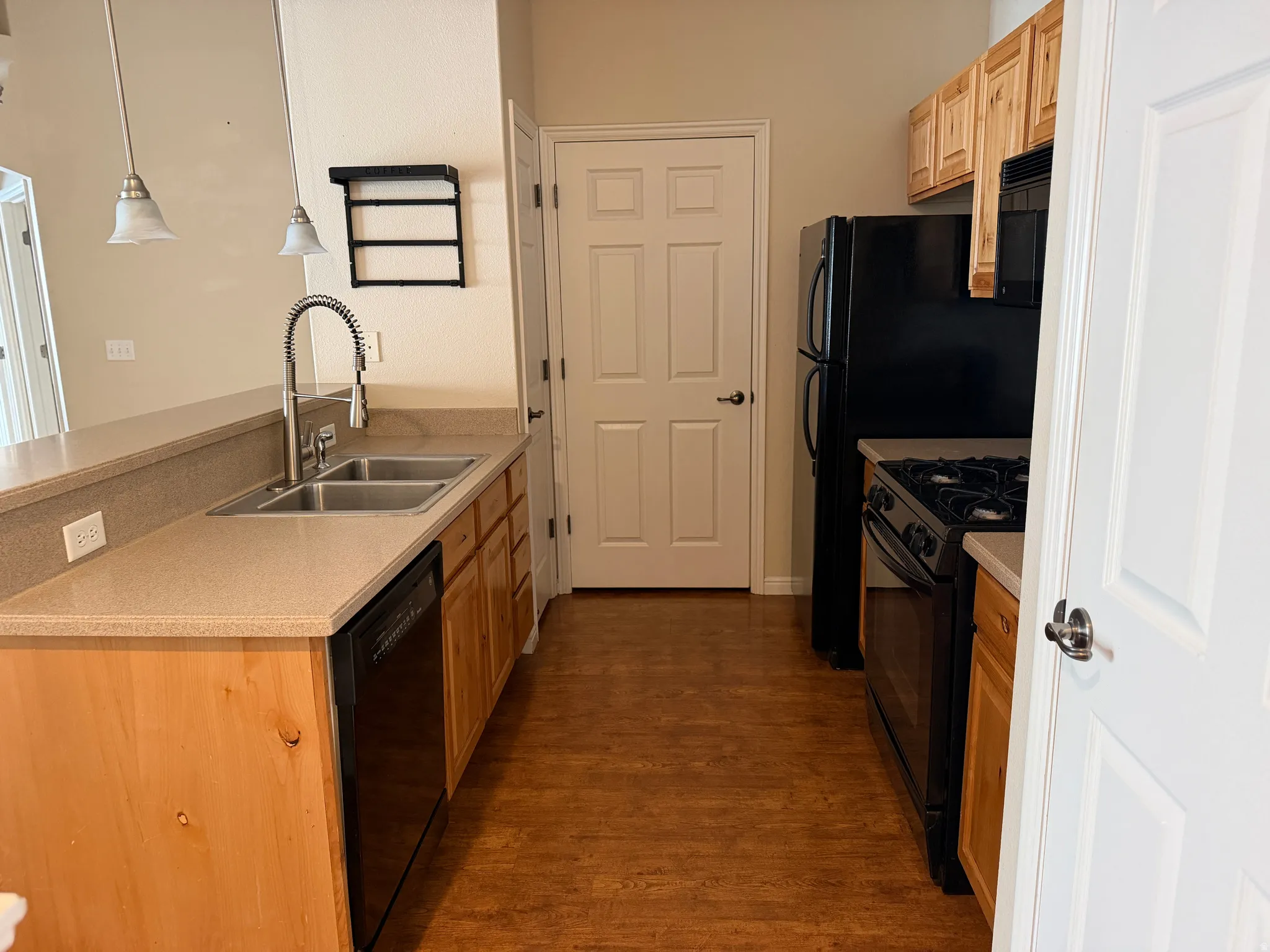 Kitchen complete with included black appliances and open to the family room.
