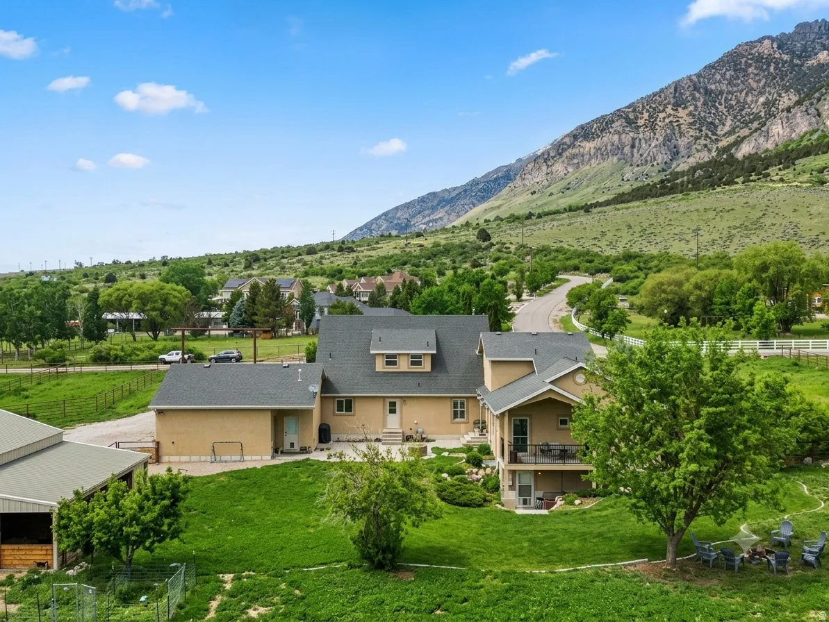 Two-story residence with a multi-level roofline, featuring an attached garage and a covered patio