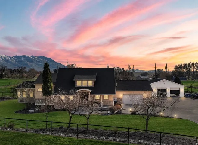 Expansive property featuring a residence, detached auxiliary structure, and a three-car garage