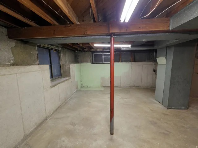 Concrete flooring with exposed ceiling joists and support beams