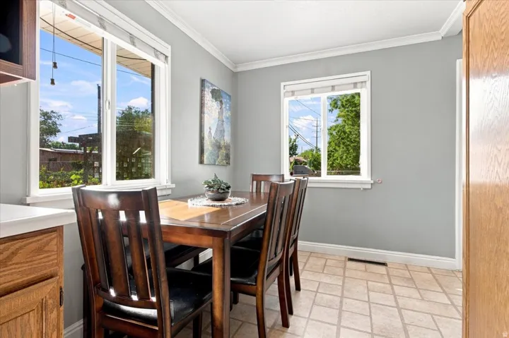 Windowed interior with gray walls, white trim, and patterned flooring