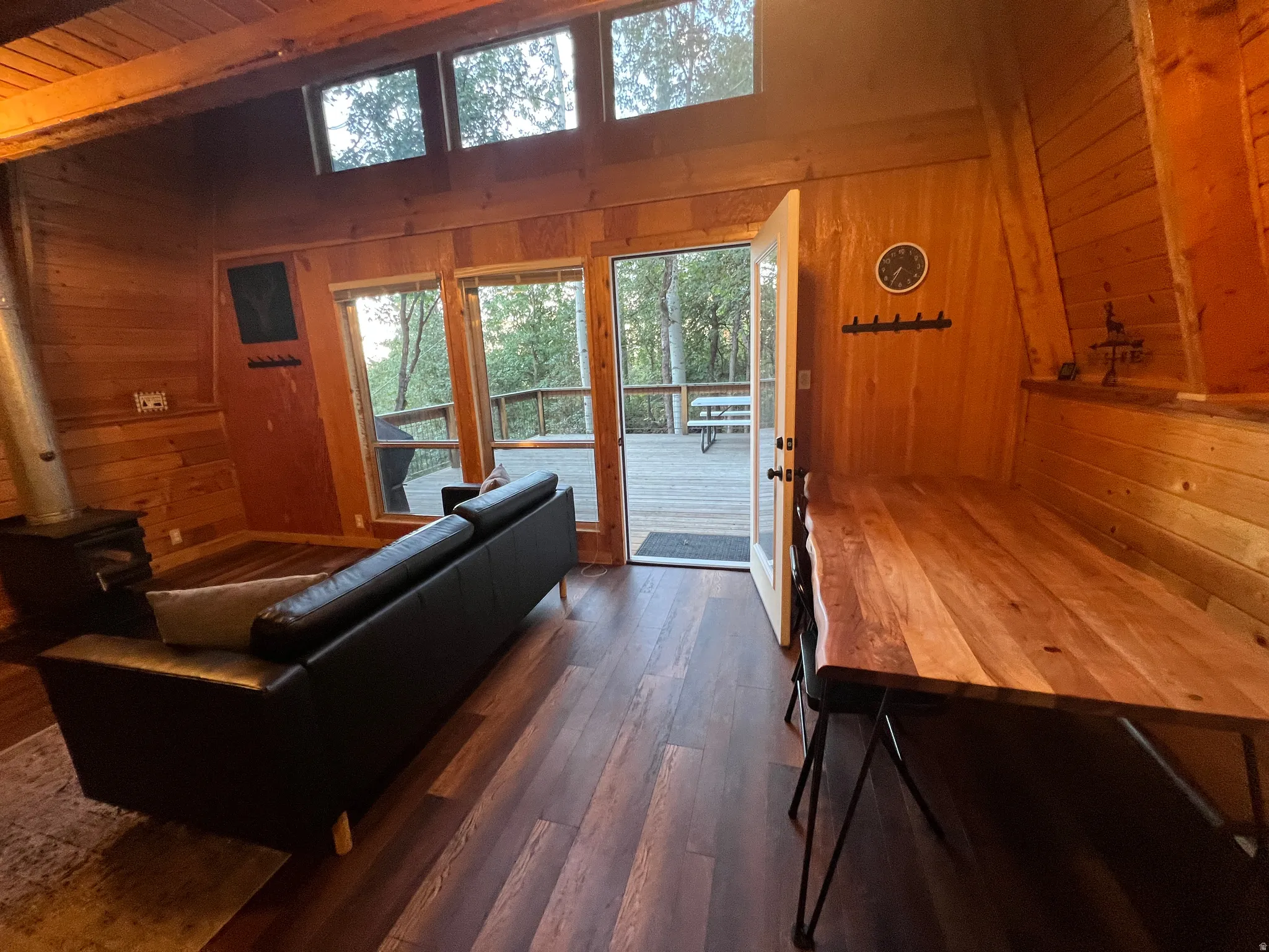 Warm wood-paneled walls looking out to to deck.