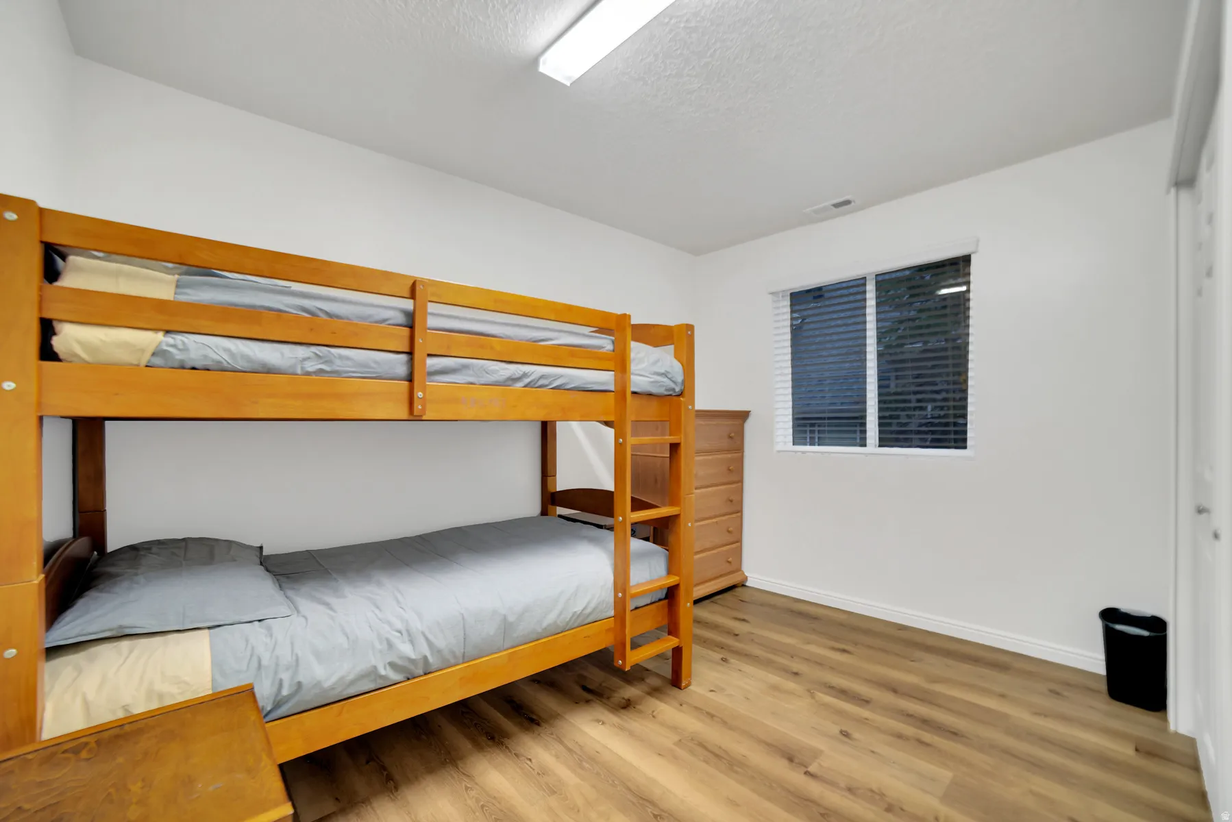 White walls with wood-finish flooring