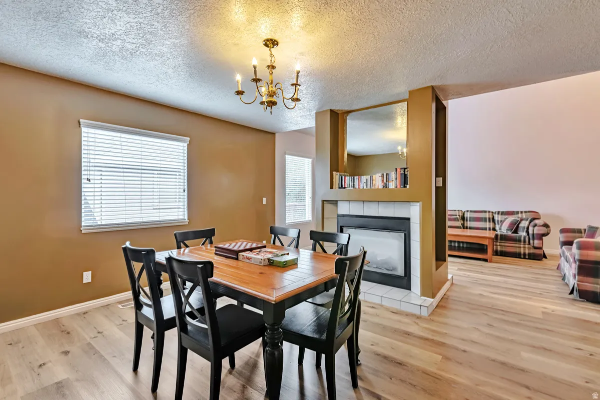 Warm-toned walls with a built-in fireplace featuring white tile surround and a wood mantel