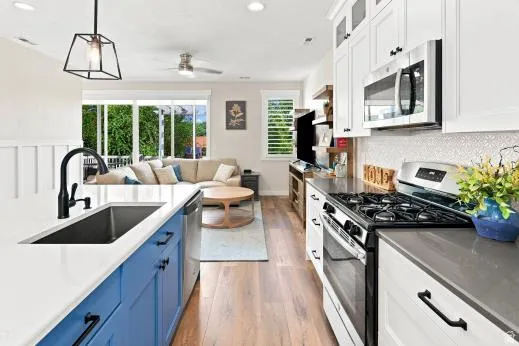 Kitchen island with blue cabinetry and an undermount sink