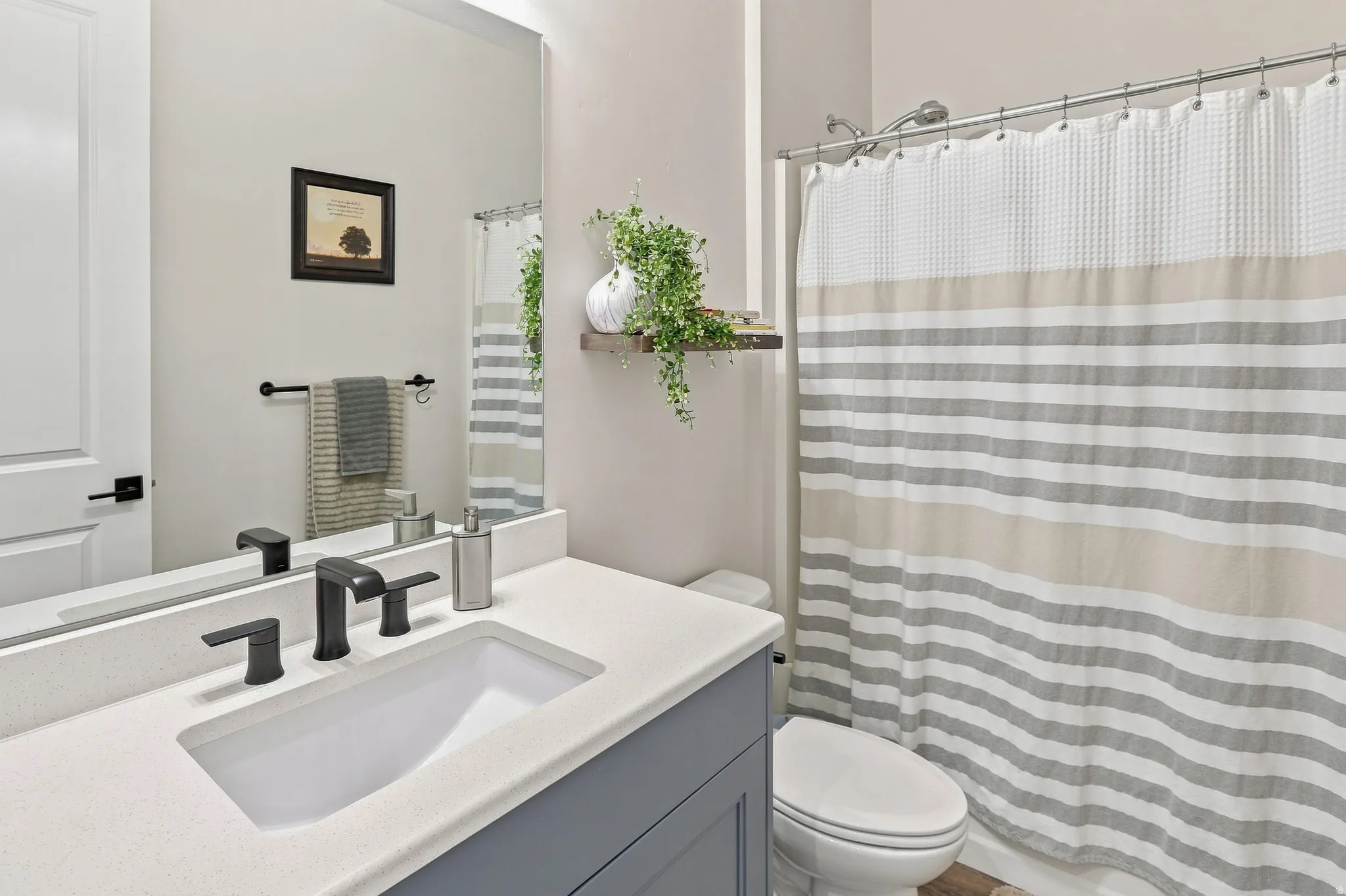 White countertop vanity with integrated sink and matte black faucet