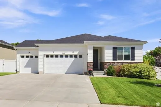 Contemporary ranch-style exterior with white siding and a dark shingle roof