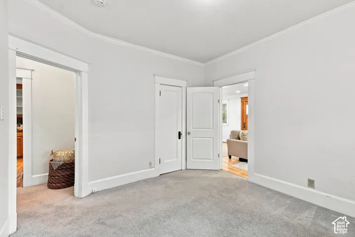 Bright, open bedroom featuring neutral walls, recessed ceiling lighting, and carpet flooring