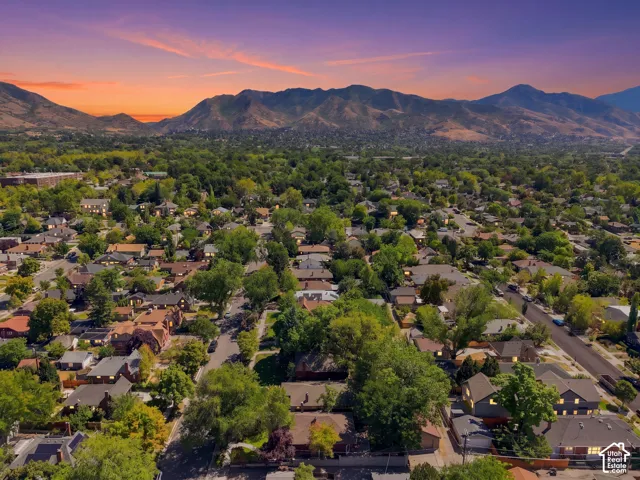 Expansive residential area with mature trees and mountain scenery