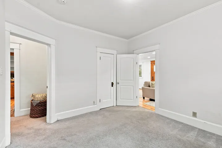 Bright, open bedroom featuring neutral walls, recessed ceiling lighting, and carpet flooring
