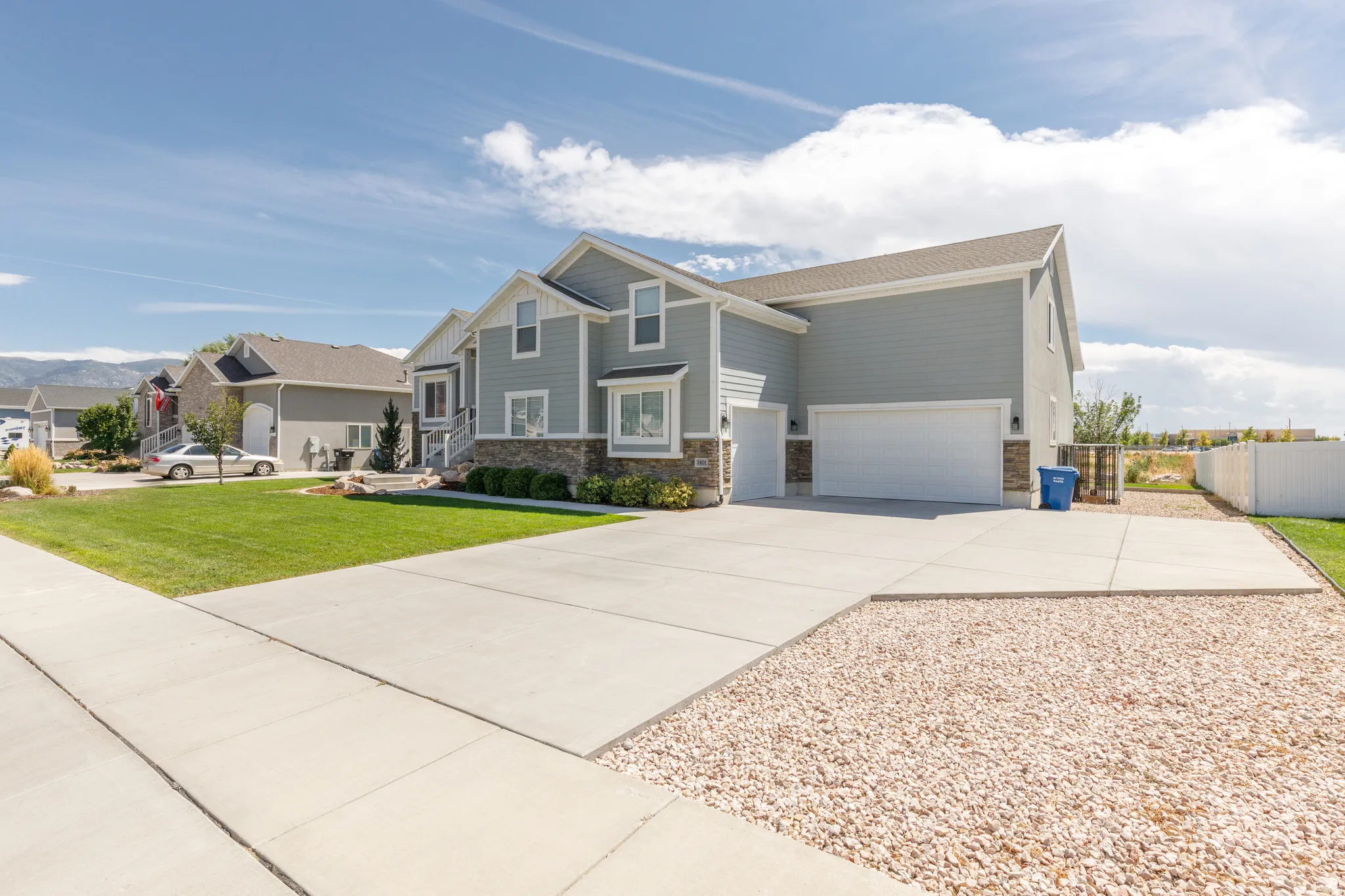 Two-story residence featuring siding and stone veneer exterior