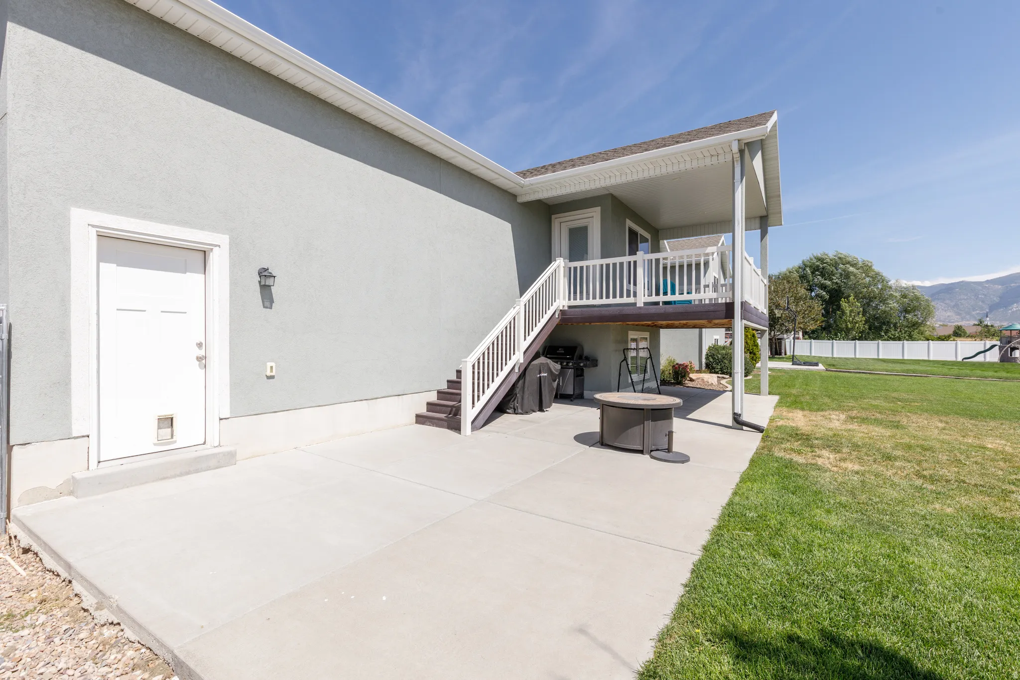 Concrete patio with direct outdoor access and a covered upper deck