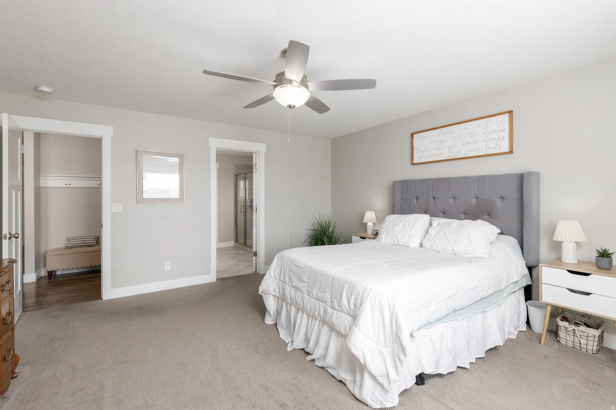 Recessed lighting, ceiling fan with light, light grey walls, white trim, and a separate doorway to a shower