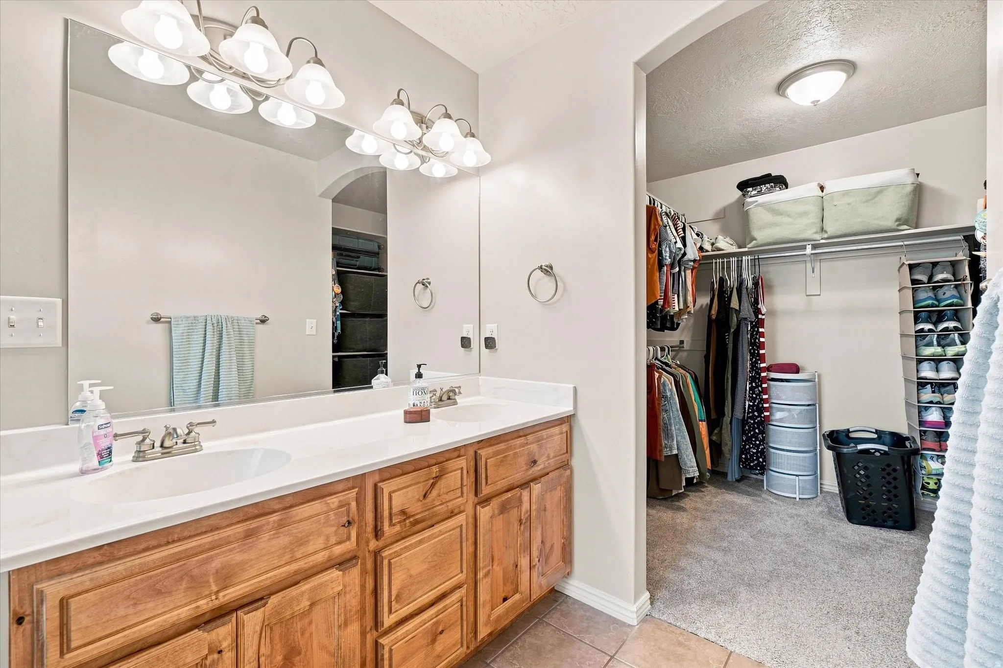Double vanity with wood-finish cabinetry and dual sinks