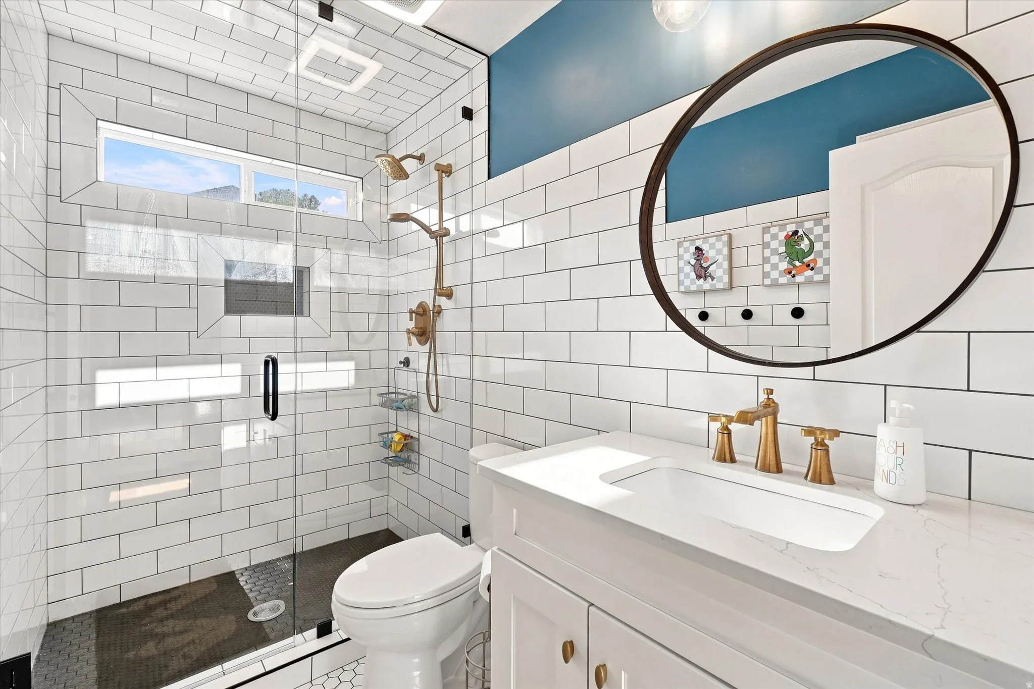 Glass-enclosed shower with subway tile surround, transom window, and a dark tile shower flooring
