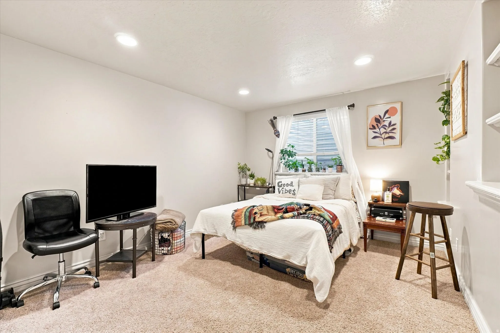 Recessed ceiling lighting, window with blinds and sheer curtains, built-in shelving, and carpeted flooring