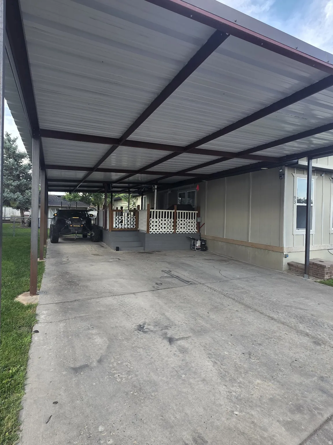 Covered carport with a metal roof and support beams
