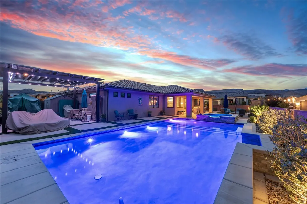 In-ground pool, integrated spa, covered patio, exterior lighting, and xeriscaping