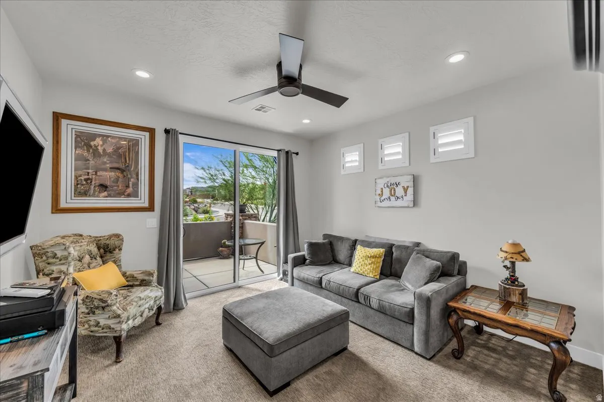 Recessed lighting, ceiling fan, and sliding glass door leading to an outdoor patio with concrete flooring