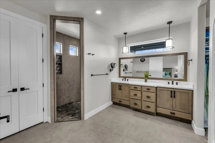 Dual vanity with wood-finish cabinetry and white countertops