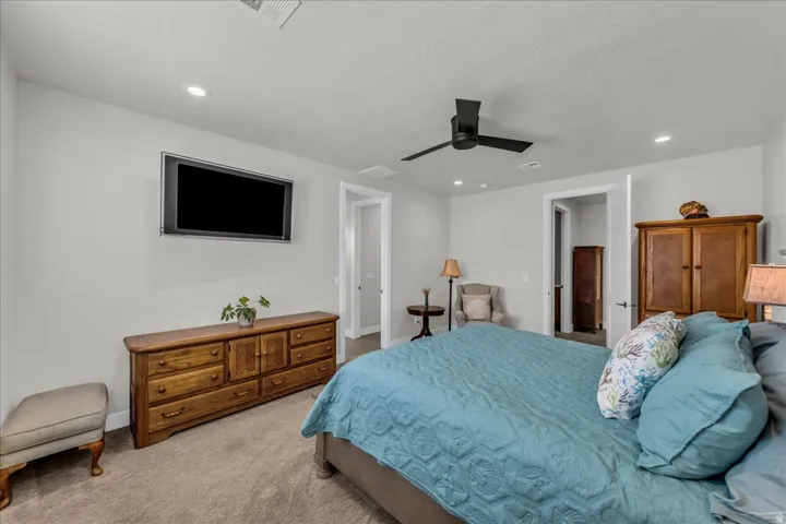 Recessed lighting, ceiling fan, and carpeted flooring