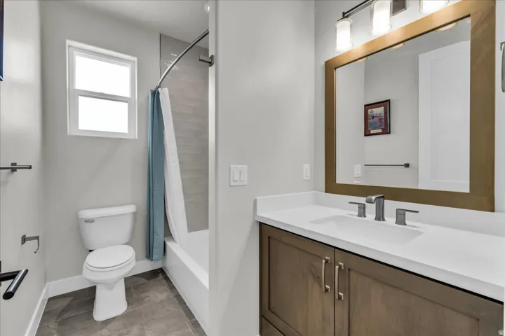 Modern vanity with wood-finish cabinetry, white countertop, and brushed nickel hardware