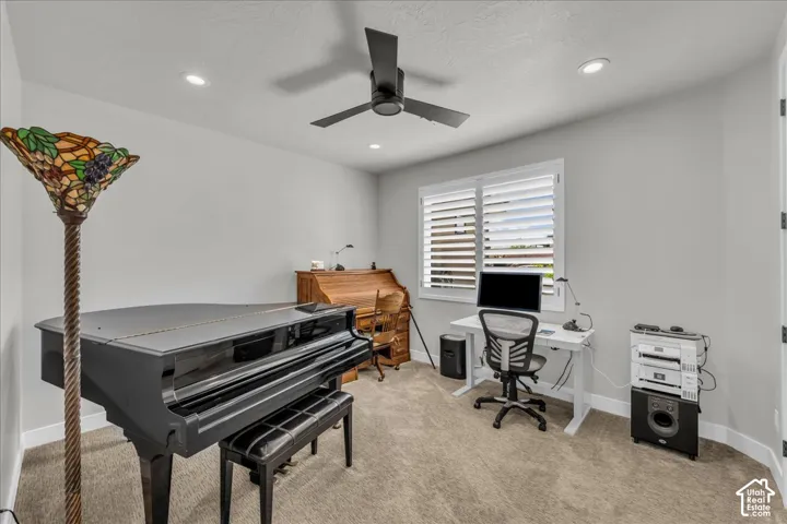 Recessed lighting, ceiling fan, window with plantation shutters, light gray wall paint, and carpeted flooring