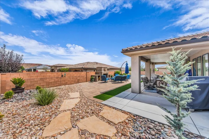 Covered patio with tile roof, concrete slab, and integrated lighting