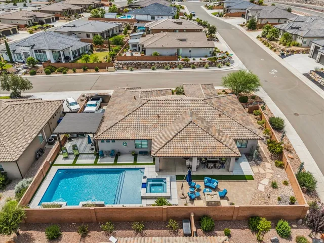 Terracotta tile roof with a covered patio, integrated swimming pool, and hot tub
