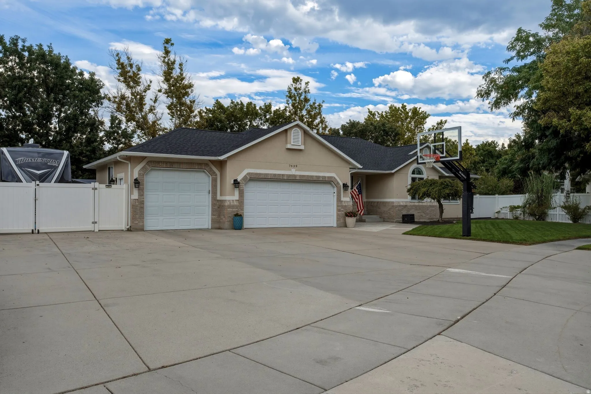 Expansive concrete driveway with clean geometric divisions providing ample parking and vehicle maneuvering space