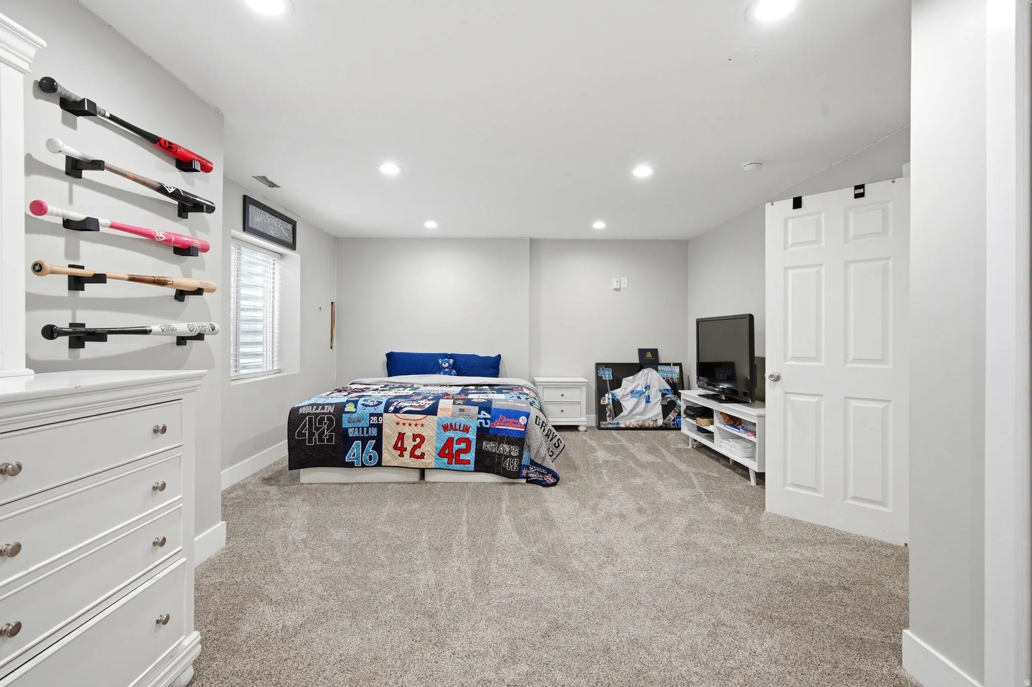 Neutral wall color, recessed lighting, window with blinds, carpeted flooring, and white trim