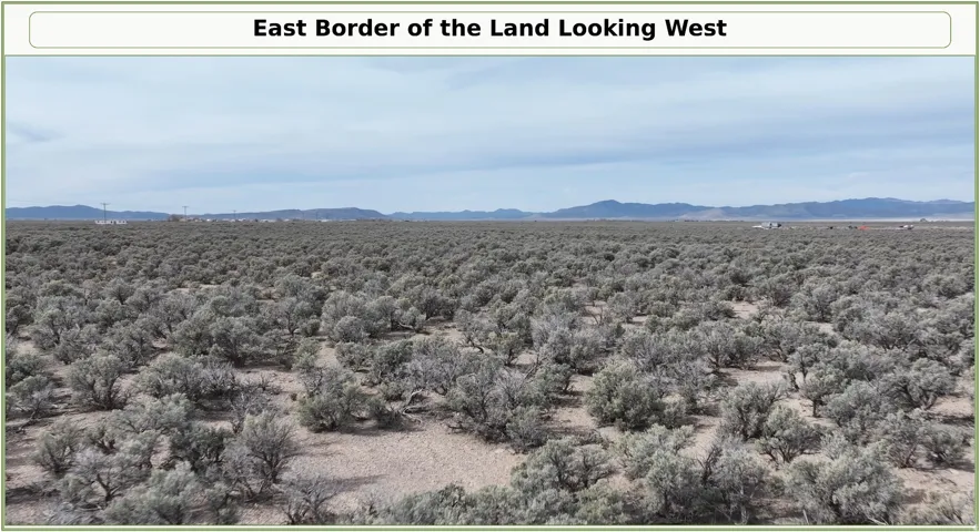 Expansive land featuring natural shrubbery and distant mountain ranges