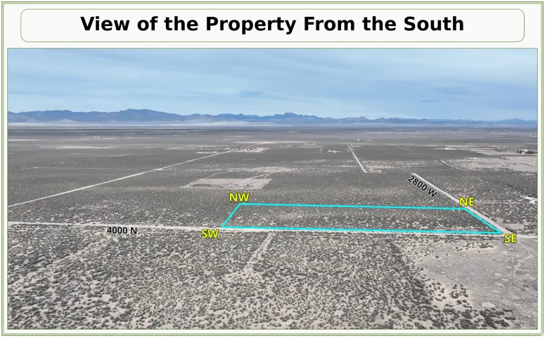 Expansive land parcel with surrounding natural vegetation and distant mountain ranges