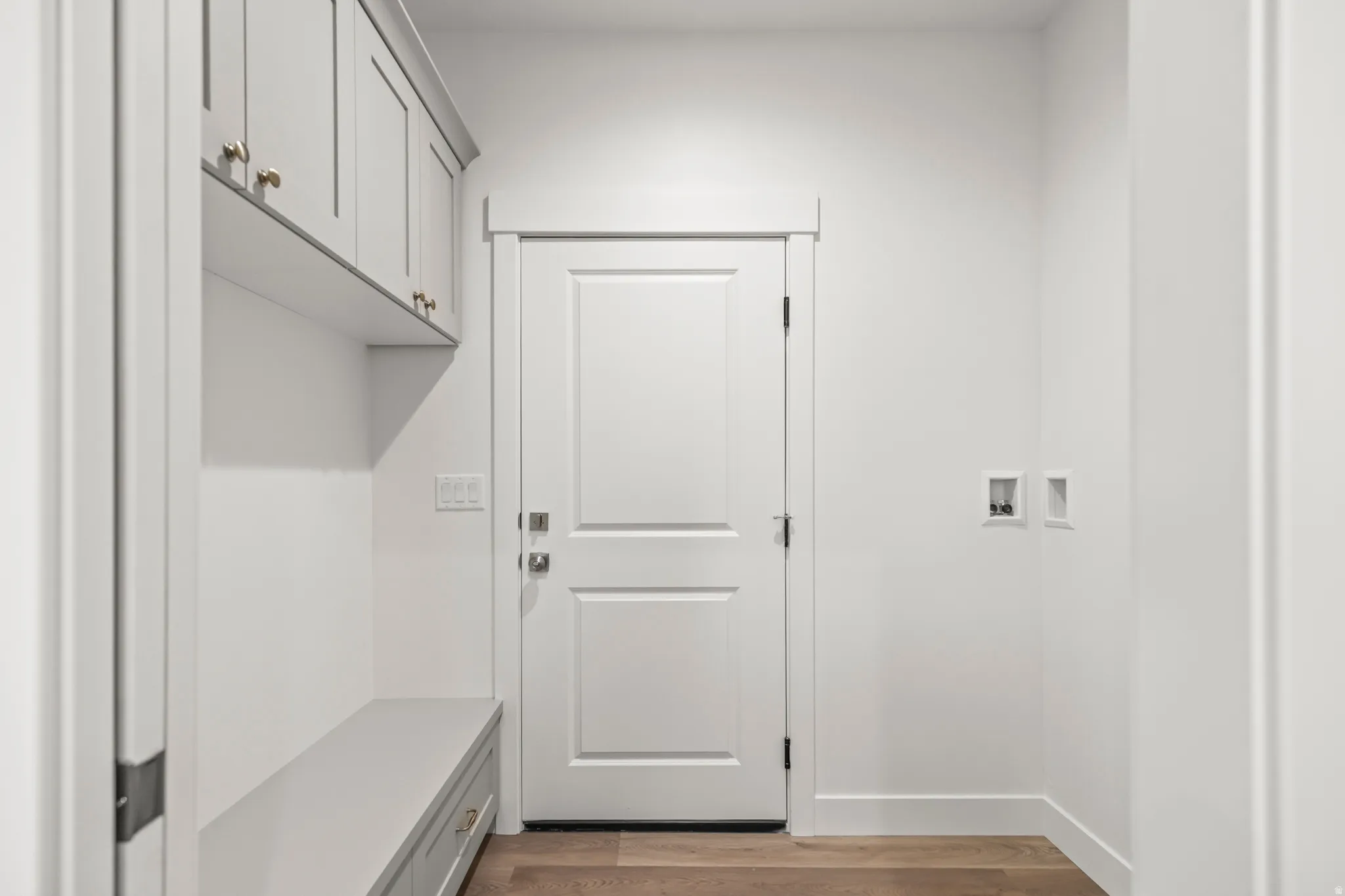 Wood-finish flooring with white baseboards