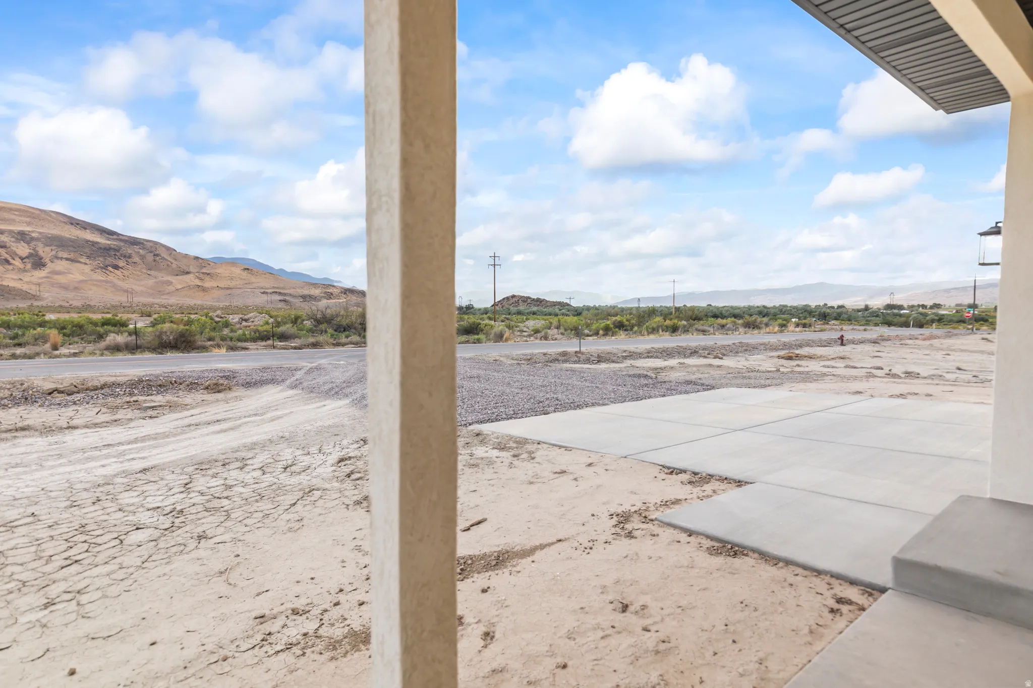 Concrete patio with a broad desert landscape and distant mountains