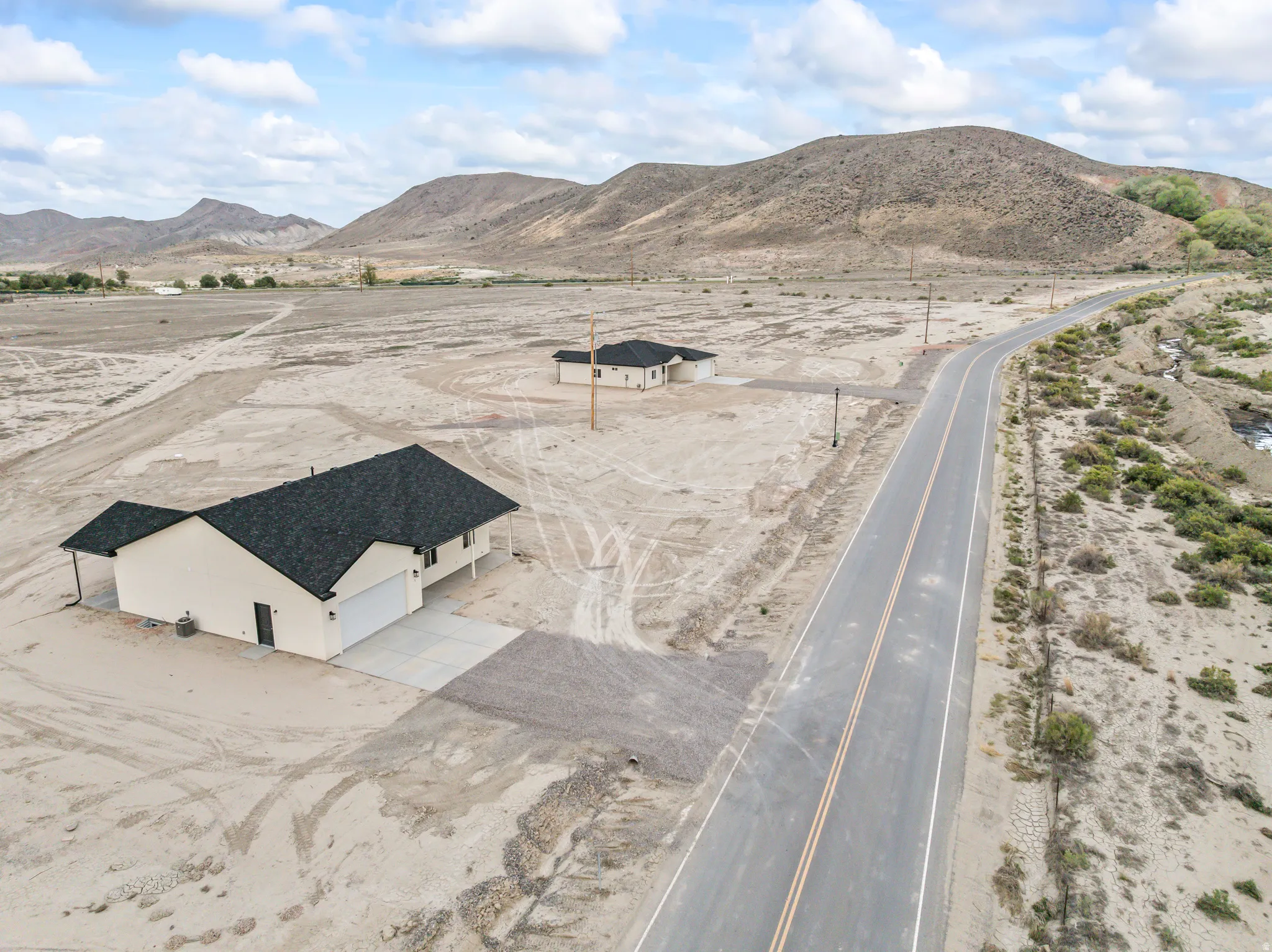 Newly constructed residence with an attached garage, a covered entry, and a covered patio