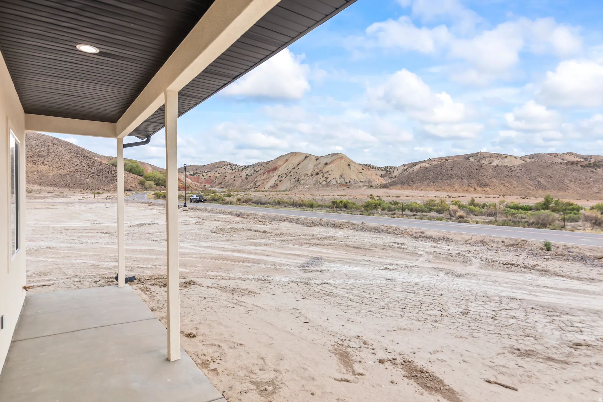 Covered concrete patio with recessed lighting and expansive mountain backdrop