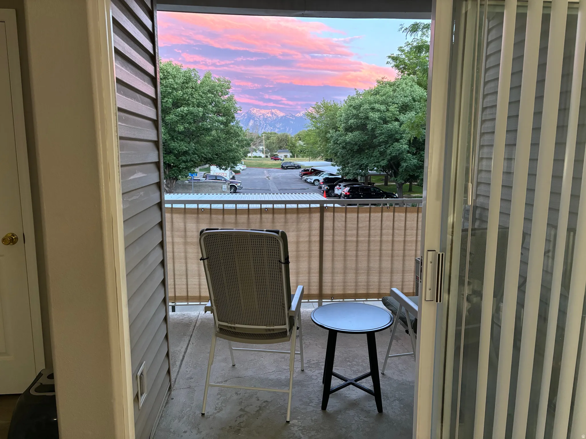 Balcony with concrete flooring and a sliding glass door