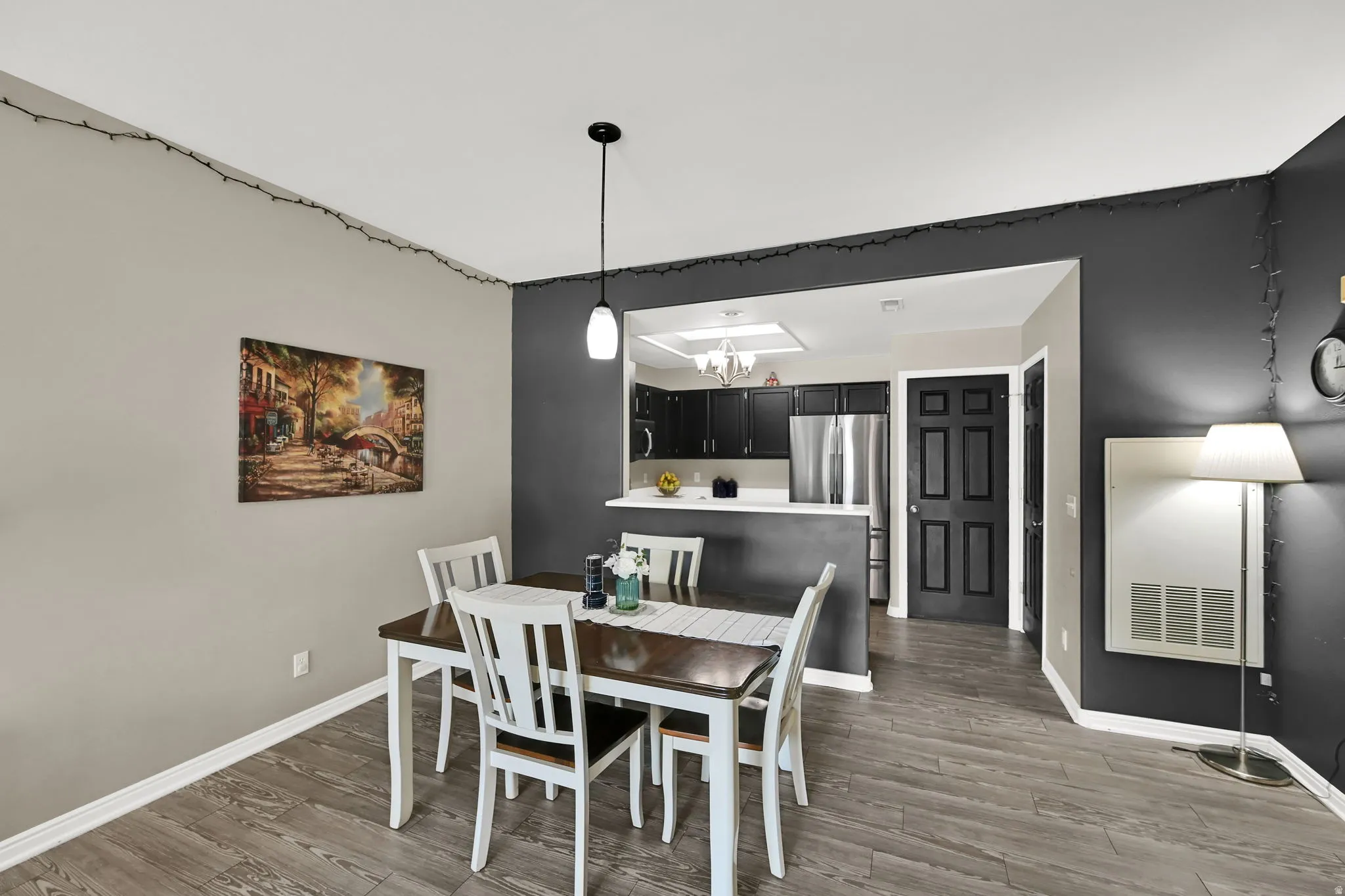 Wood-finish flooring throughout, with a peninsula counter and a kitchen recess
