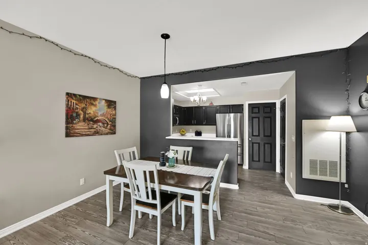 Wood-finish flooring throughout, with a peninsula counter and a kitchen recess