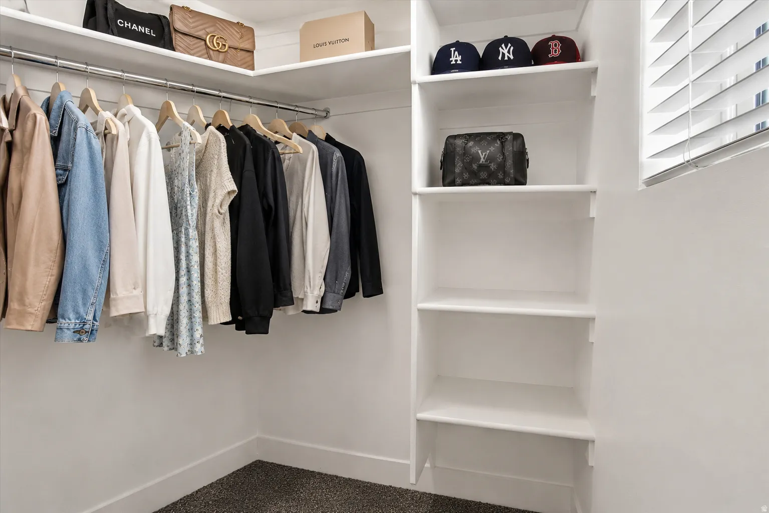 Customizable closet system featuring upper shelving, multiple hanging rods, and built-in vertical shelving. (Virtually staged for decor ideas)
