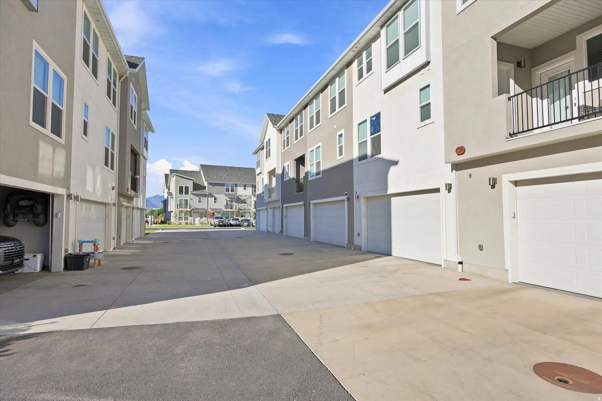 Modern multi-story buildings featuring stucco exteriors and attached garages.