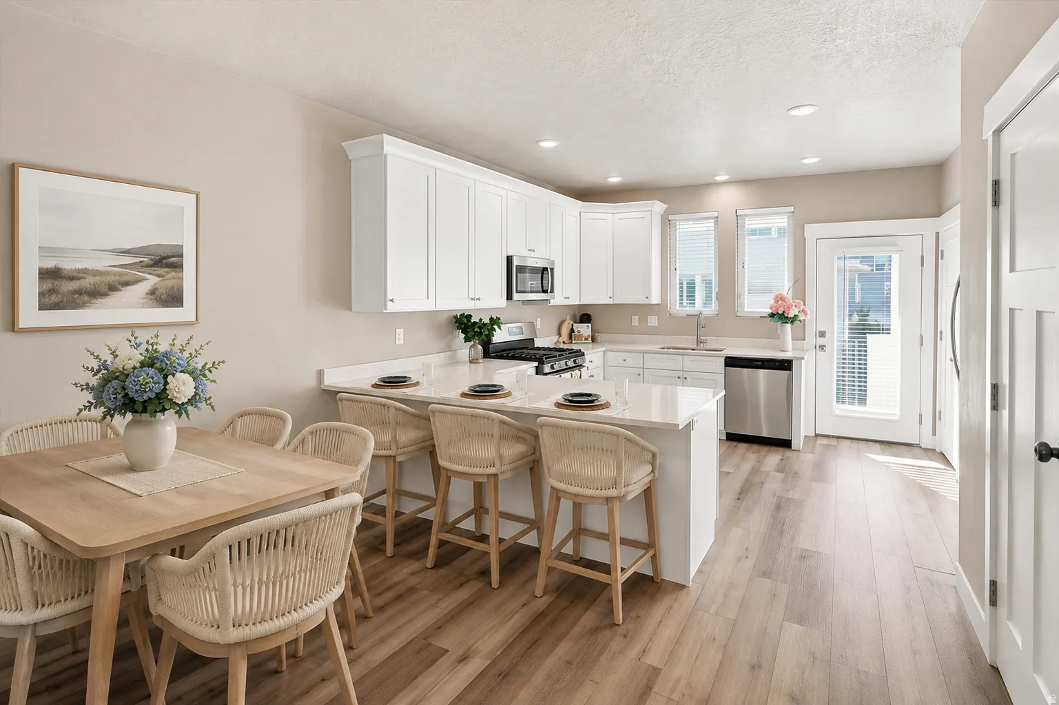 New kitchen featuring white shaker cabinetry, stainless steel appliances, a white island with bar seating, and wood-finish flooring. Virtually staged for decor ideas.