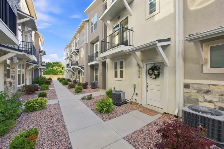 Contemporary exterior with stucco and stone veneer accents.