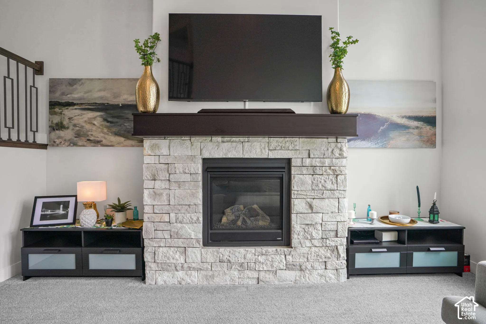 Stone-clad fireplace with dark wood mantel and a gas insert