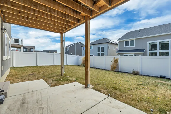 Covered concrete patio with wood-finish decking above