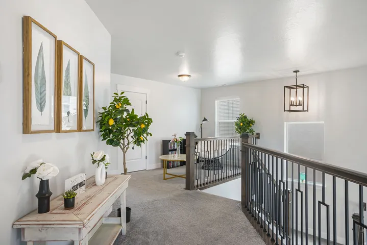Carpeted landing with white walls, a white ceiling, and white trim