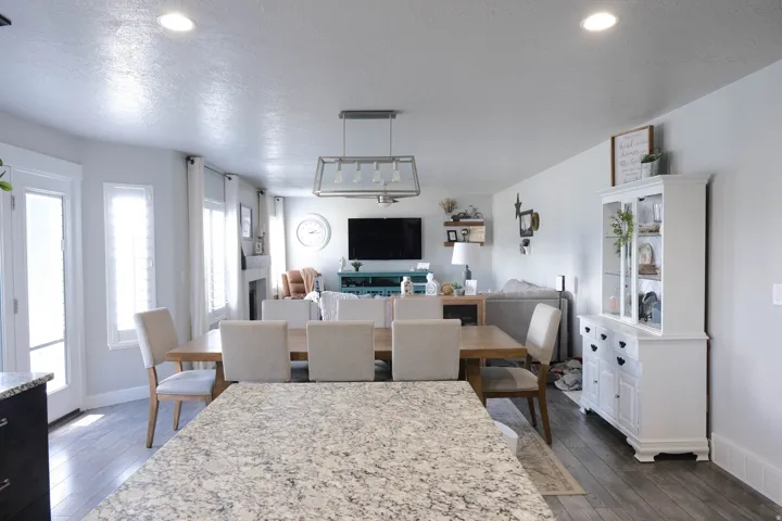 Open-concept living space with recessed lighting, wood-finish flooring, and white interior doors